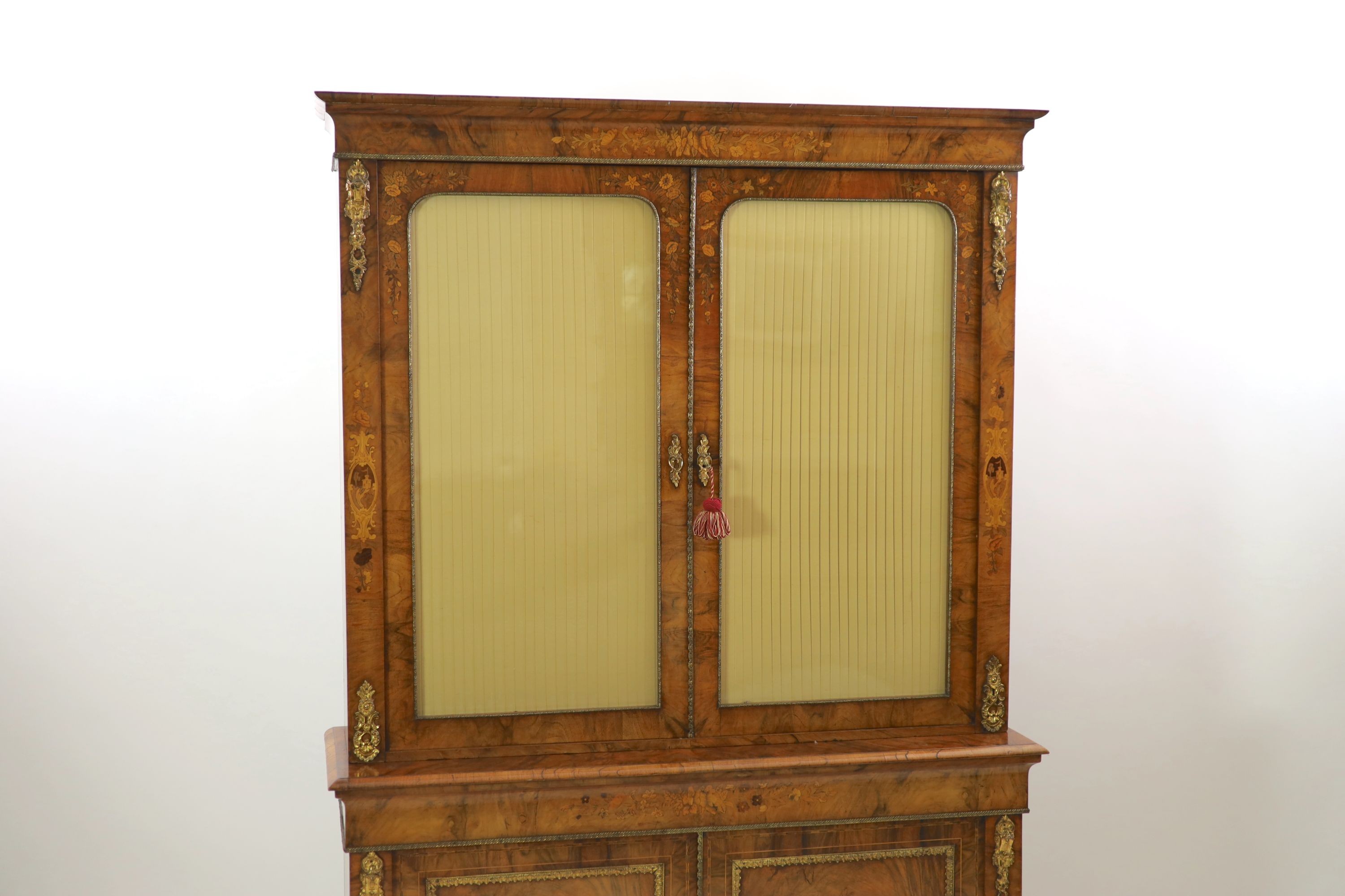 A Victorian ormolu mounted marquetry inlaid walnut bookcase, W.127cm D.40cm H.208cm